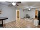 Cozy living room features wood floors, ceiling fans, and a comfortable armchair, creating a relaxing atmosphere at 4180 Mount Paran Dr, Social Circle, GA 30025