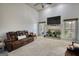 Inviting living room features a fireplace, large windows and comfortable leather sofas at 4180 Mount Paran Dr, Social Circle, GA 30025