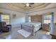 Spacious main bedroom with a tray ceiling, a ceiling fan, and natural light at 4180 Mount Paran Dr, Social Circle, GA 30025