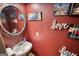Powder room featuring a stylish vanity, decorative mirror, and fun wall decor at 4180 Mount Paran Dr, Social Circle, GA 30025