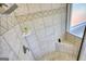 Tiled shower featuring a rain shower head, built-in shelf, and a corner bench at 4180 Mount Paran Dr, Social Circle, GA 30025