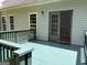 Back deck of home features access to the home, railings, and painted blue floor at 2828 Hicks Sw Rd, Marietta, GA 30060