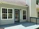 Back deck with painted blue floor, railings, and access to the home through a glass door at 2828 Hicks Sw Rd, Marietta, GA 30060