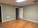 Finished basement with laminate floors, a door, neutral paint, and ample lighting at 2828 Hicks Sw Rd, Marietta, GA 30060