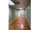Finished basement area with laminate flooring and neutral walls illuminated by fluorescent lighting at 2828 Hicks Sw Rd, Marietta, GA 30060