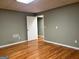 Finished basement with laminate flooring, neutral walls, and a door to another room at 2828 Hicks Sw Rd, Marietta, GA 30060