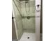 A well-maintained bathroom featuring tiled shower, light green and white tile, and modern fixtures at 2828 Hicks Sw Rd, Marietta, GA 30060