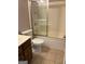 Modest bathroom features a standard shower-tub combo with sliding glass doors, toilet, sink and neutral finishes at 2828 Hicks Sw Rd, Marietta, GA 30060