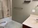 Small bathroom features a standard shower-tub combo with sliding glass doors, toilet, sink and neutral finishes at 2828 Hicks Sw Rd, Marietta, GA 30060
