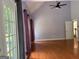Bedroom featuring hardwood floors, a ceiling fan, and a large window providing natural light at 2828 Hicks Sw Rd, Marietta, GA 30060