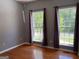 Cozy bedroom with hardwood floors and windows bringing in natural light with outside views at 2828 Hicks Sw Rd, Marietta, GA 30060