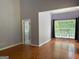 Spacious bedroom featuring hardwood floors, high ceilings, and a bright window with natural light at 2828 Hicks Sw Rd, Marietta, GA 30060