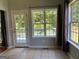 Breakfast area with three windows, door to patio and backyard view at 2828 Hicks Sw Rd, Marietta, GA 30060