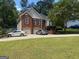 Charming two-story brick home featuring an attached two car garage and a well manicured front yard at 2828 Hicks Sw Rd, Marietta, GA 30060