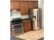 Kitchen with stainless steel appliances, tiled floor and brown cabinets for storage at 2828 Hicks Sw Rd, Marietta, GA 30060