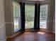 Sunlit living area with hardwood floors, large windows, and neutral color palette at 2828 Hicks Sw Rd, Marietta, GA 30060