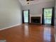 Spacious living room features a brick fireplace, windows, hardwood floors, and a vaulted ceiling at 2828 Hicks Sw Rd, Marietta, GA 30060