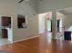Open floor plan with hardwood floors seamlessly connecting the kitchen, dining, and living spaces at 2828 Hicks Sw Rd, Marietta, GA 30060