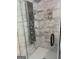 Modern shower featuring a sleek chrome panel with multiple body jets and glass shelving for storage at 2828 Hicks Sw Rd, Marietta, GA 30060