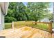 Spacious wooden deck overlooking a private backyard with mature trees and green grass at 106 June Ct, Hampton, GA 30228