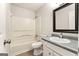 Bathroom featuring single vanity, white cabinets, granite countertops, shower-tub combo and tile floors at 106 June Ct, Hampton, GA 30228
