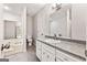 Bathroom featuring single vanity, white cabinets, granite countertops, soaking tub and tile floors at 106 June Ct, Hampton, GA 30228