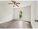 Bedroom featuring hardwood floors, ceiling fan, neutral paint, and large window at 106 June Ct, Hampton, GA 30228