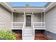 Welcoming front porch with white railings and steps leading to the front door, perfect for enjoying the outdoors at 106 June Ct, Hampton, GA 30228