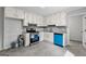 Updated kitchen featuring white cabinets, gray backsplash and countertop, with stainless steel appliances at 106 June Ct, Hampton, GA 30228