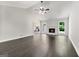 Bright living room with dark wood floors, white fireplace, and lots of natural light at 106 June Ct, Hampton, GA 30228