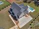 An aerial view of a new home showcasing the large driveway, fenced yard and outdoor living space at 260 Cicely Way, Tyrone, GA 30290