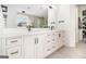 Bright bathroom features double sinks, black hardware, walk-in shower, and built-in shelving at 260 Cicely Way, Tyrone, GA 30290