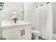 Contemporary bathroom featuring a white vanity, modern black fixtures, and a shower with a white curtain at 260 Cicely Way, Tyrone, GA 30290