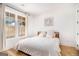 Bright bedroom boasts hardwood floors, a large window, and neutral decor at 260 Cicely Way, Tyrone, GA 30290