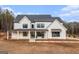 Beautiful two-story home features a classic white exterior with dark trim and a welcoming front porch at 260 Cicely Way, Tyrone, GA 30290