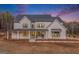 Stunning two-story home features a classic white exterior with dark trim and a welcoming front porch at 260 Cicely Way, Tyrone, GA 30290