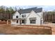 Classic white siding and black trim highlight this home's exterior, complemented by a cozy, covered front porch at 260 Cicely Way, Tyrone, GA 30290