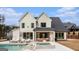 Back exterior of a modern farmhouse with a patio, an inground pool, and a spacious yard at 260 Cicely Way, Tyrone, GA 30290