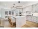 Modern kitchen featuring white cabinets, large island with seating, and stainless steel appliances at 260 Cicely Way, Tyrone, GA 30290