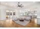 Bright, open living room with modern furnishings and seamless flow into kitchen and outdoor patio at 260 Cicely Way, Tyrone, GA 30290