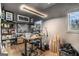 Modern office space with an adjustable desk, creative artwork, and bright lighting fixture at 260 Cicely Way, Tyrone, GA 30290