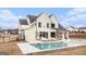 Back exterior of a modern farmhouse with a pool, a patio, and a spacious yard at 260 Cicely Way, Tyrone, GA 30290