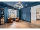 Stylish office space with blue walls, wood floors, modern lighting, and comfortable seating area at 260 Cicely Way, Tyrone, GA 30290