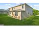 Exterior backyard view with green grass and the house's tan siding at 6533 Waterford Sw St, Atlanta, GA 30331