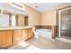 Bathroom featuring a vanity, toilet, soaking tub, and glass shower enclosure at 6533 Waterford Sw St, Atlanta, GA 30331