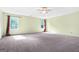 Spacious bedroom features plush carpet, ceiling fan, and sun-filled windows at 6533 Waterford Sw St, Atlanta, GA 30331