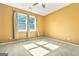 Bright bedroom featuring two windows, tan walls, and soft carpet at 6533 Waterford Sw St, Atlanta, GA 30331