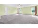 Carpeted bedroom features windows for natural light and access to multiple doors at 6533 Waterford Sw St, Atlanta, GA 30331
