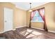 Cozy bedroom with hardwood floors, neutral paint and a large window at 6533 Waterford Sw St, Atlanta, GA 30331