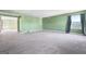 Large bonus room featuring bright green walls, gray carpet, and a view into another room at 6533 Waterford Sw St, Atlanta, GA 30331